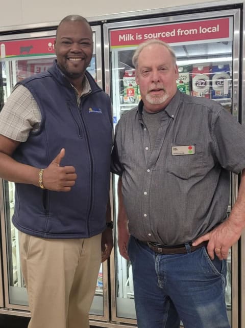 Two Stop & Shop workers smiling in a grocery store.