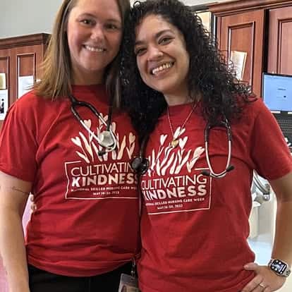 Two Apple Rehab workers wearing red UFCW shirts and stethoscopes.