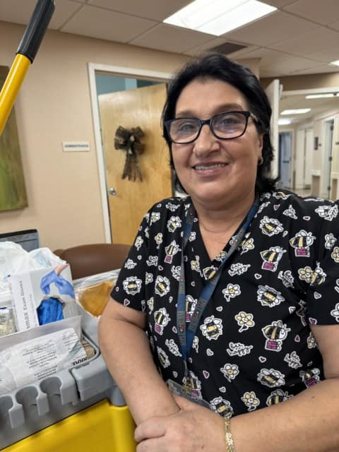 Apple Rehab worker smiling at her workplace.
