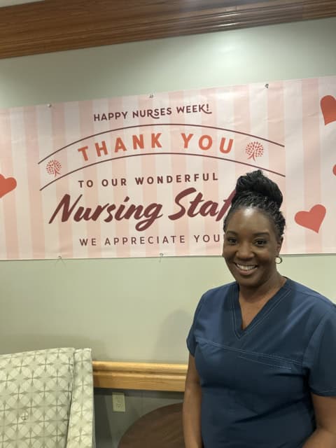 Autumn Lake healthcare worker beneath a Nurses Week appreciation banner.