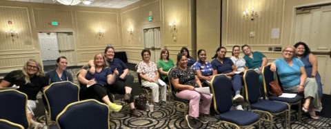 Complete Care workers seated in a conference room.