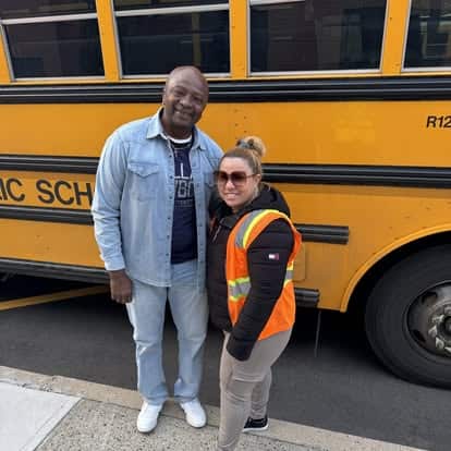 School bus safety awareness with a driver and a crossing guard.