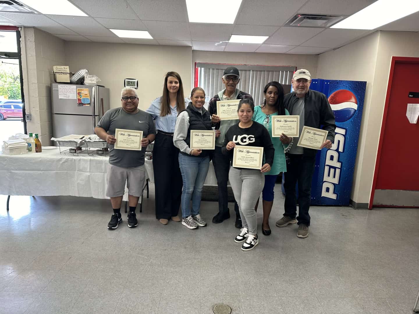 DATTCO and First Student workers holding certificates.