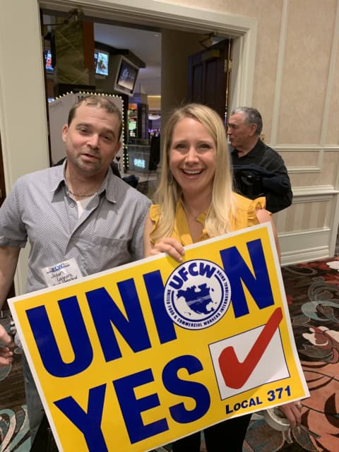 Shop Rite workers holding a Union Yes sign at a UFCW Local 371 event.