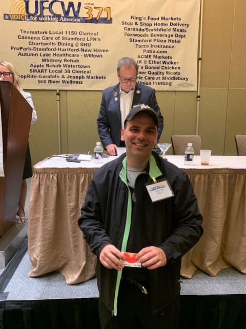 Shop Rite worker smiling at a UFCW Local 371 event.