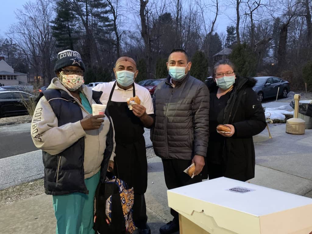 Whitney Rehabilitation workers wearing masks at an outdoor event.