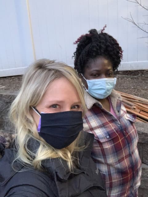 Two Whitney Rehabilitation workers wearing masks outdoors.