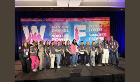 Group of women union members on stage at UFCW convention.